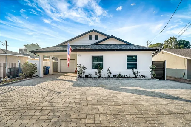 a front view of a house with yard and garage