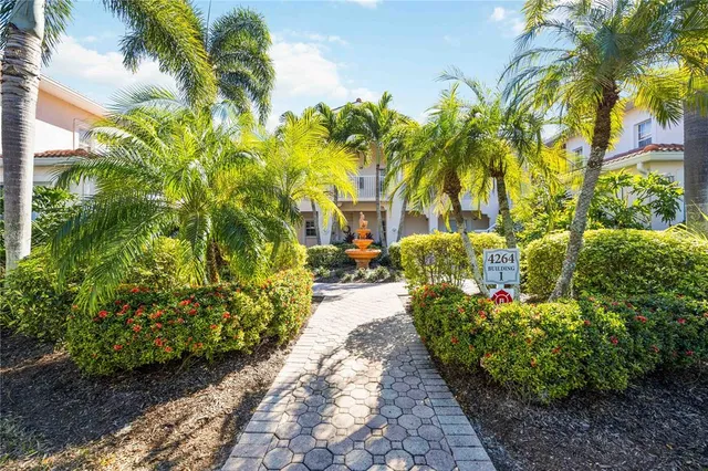 a view of a pathway with flower garden