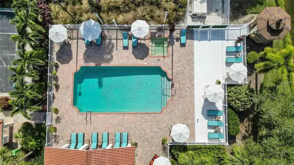 an aerial view of a house with a swimming pool and outdoor seating