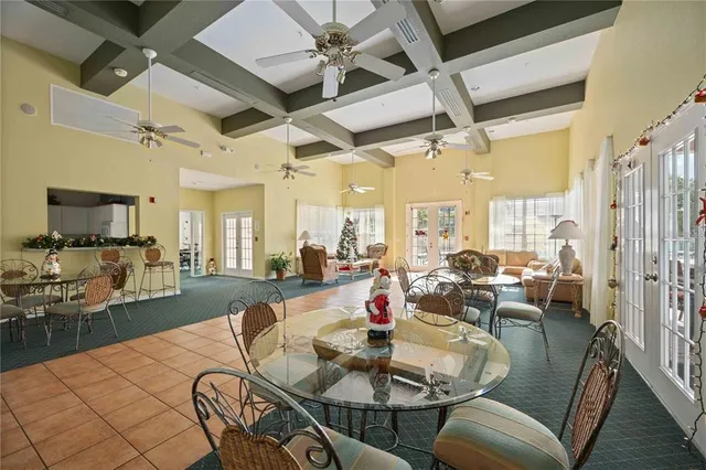 a living room with furniture kitchen view and a large window