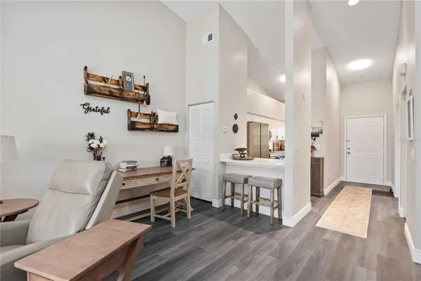 a view of a workspace with furniture and wooden floor
