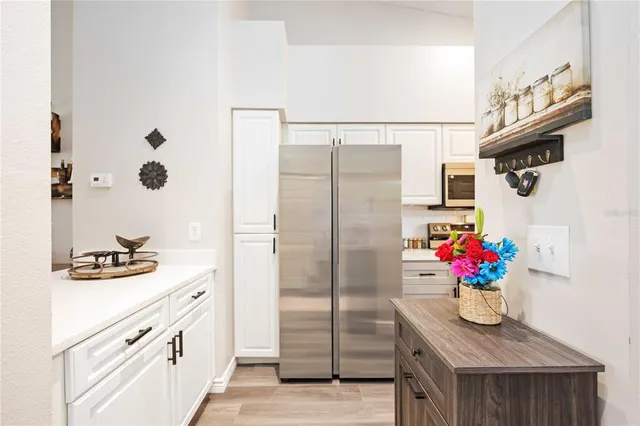a kitchen with stainless steel appliances granite countertop a refrigerator and a stove