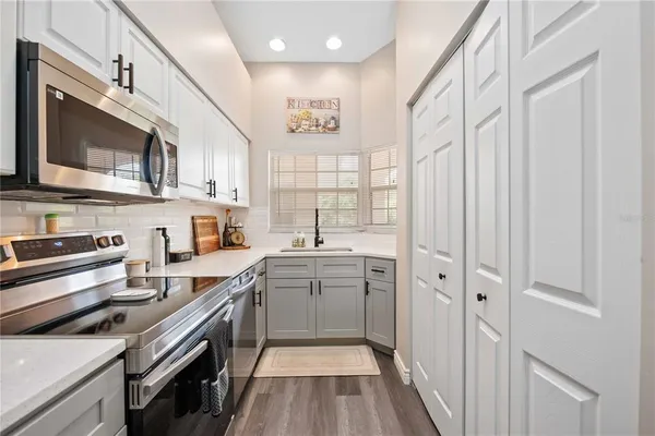 a kitchen with a sink stove and microwave