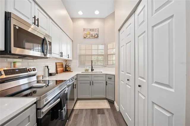 a kitchen with a sink stove and microwave