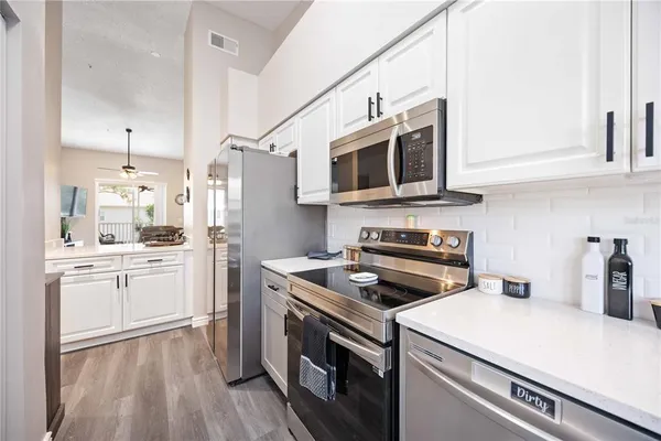 a kitchen with a sink stove and microwave