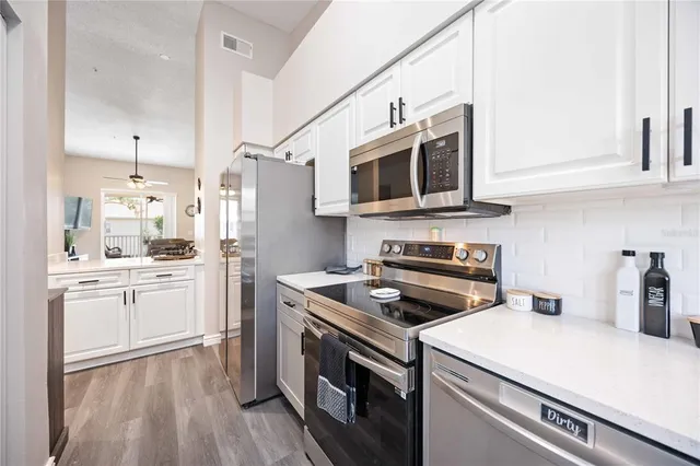 a kitchen with a sink stove and microwave