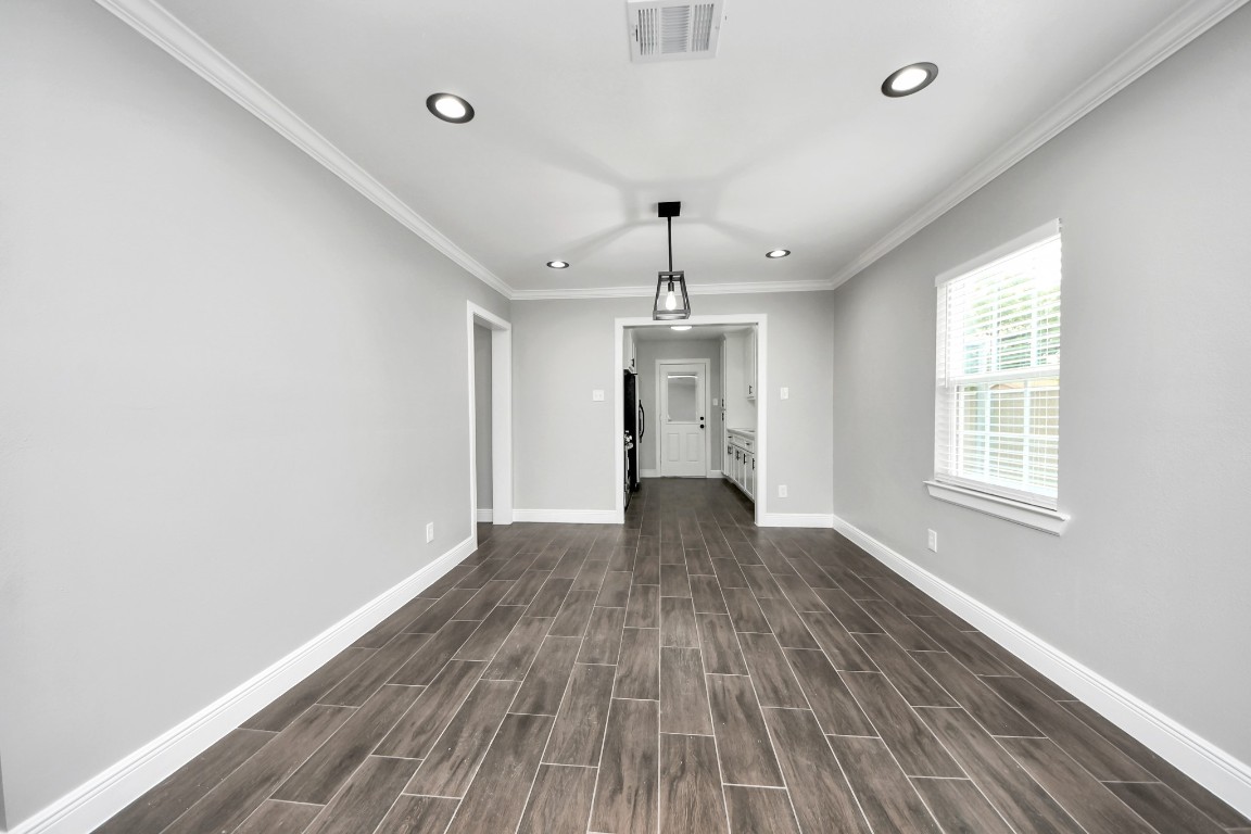 135 Rustic Drive Pasadena, TX 77502 - Photo 12 of 31 wooden floor in an empty room with a window
