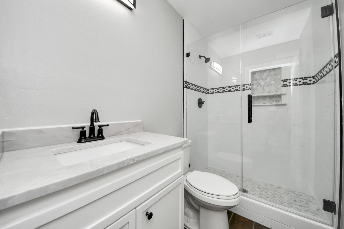 135 Rustic Drive Pasadena, TX 77502 - Photo 21 of 31 a bathroom with a sink a toilet and shower