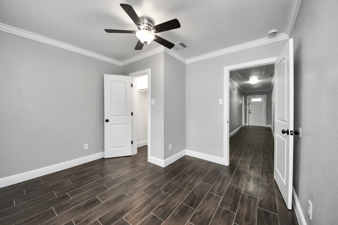 135 Rustic Drive Pasadena, TX 77502 - Photo 29 of 31 an empty room with wooden floor and a ceiling fan