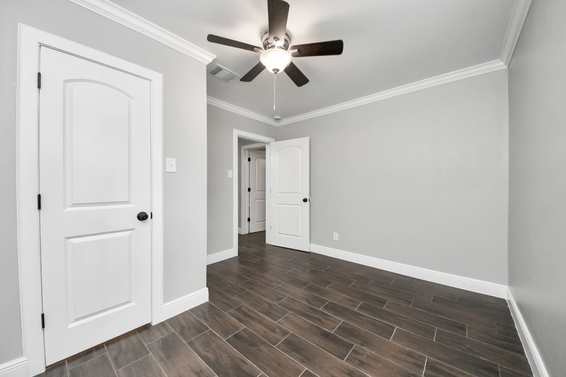 135 Rustic Drive Pasadena, TX 77502 - Photo 30 of 31 an empty room with wooden floor ceiling fan and windows