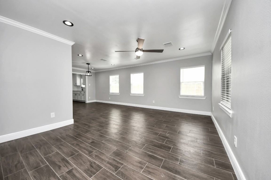 135 Rustic Drive Pasadena, TX 77502 - Photo 9 of 31 an empty room with wooden floor and windows