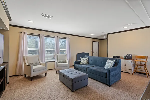 a living room with furniture and a large window