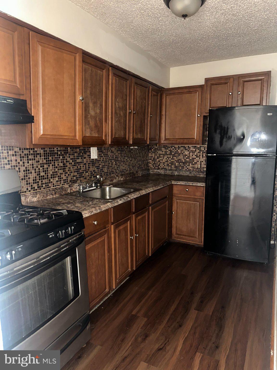 3817 Swann Road, Unit 101 Suitland, MD 20746 - Photo 3 of 8 Modern kitchen with rich wood tones.