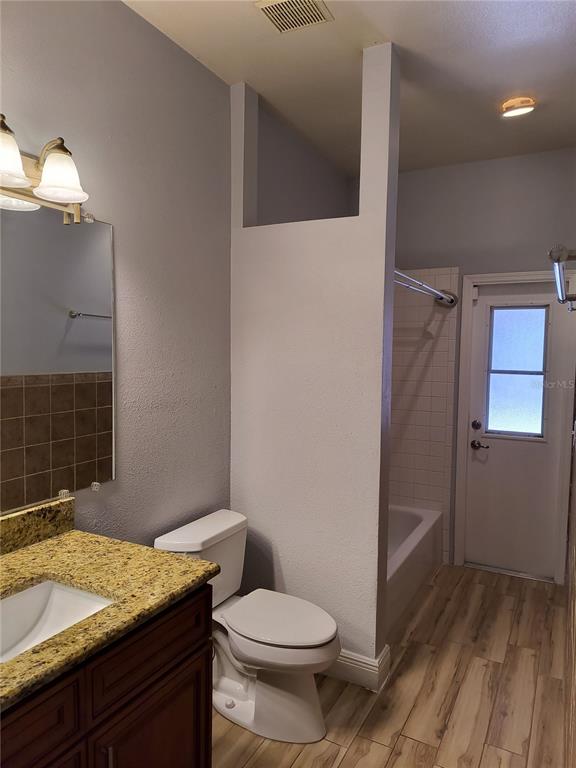 3201 Settlers Trail St. Cloud, FL 34772 - Photo 12 of 38 a bathroom with a granite countertop sink toilet and shower