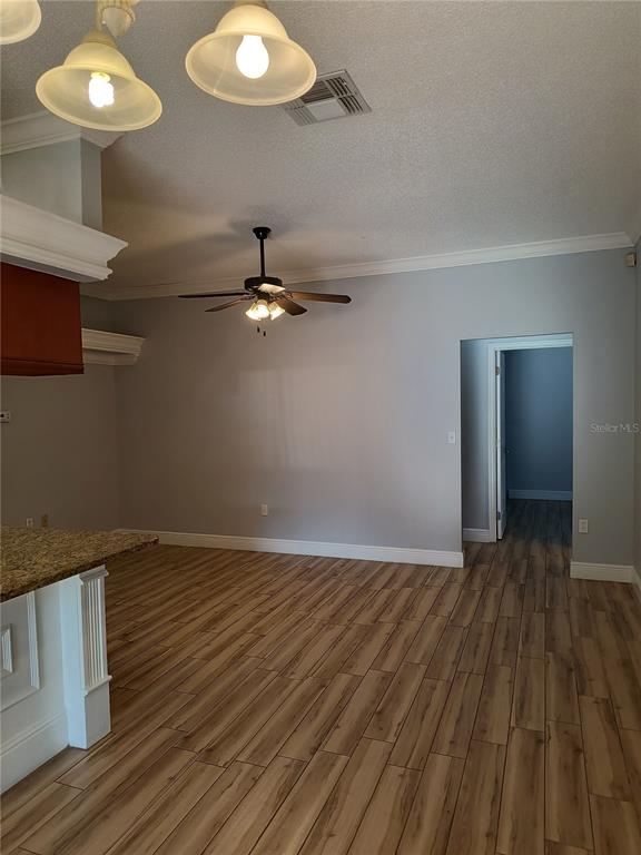 3201 Settlers Trail St. Cloud, FL 34772 - Photo 18 of 38 a view of an empty room with wooden floor and a fan