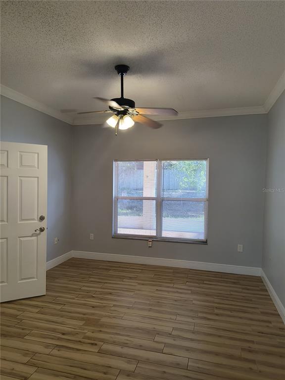 3201 Settlers Trail St. Cloud, FL 34772 - Photo 22 of 38 an empty room with wooden floor fan and window