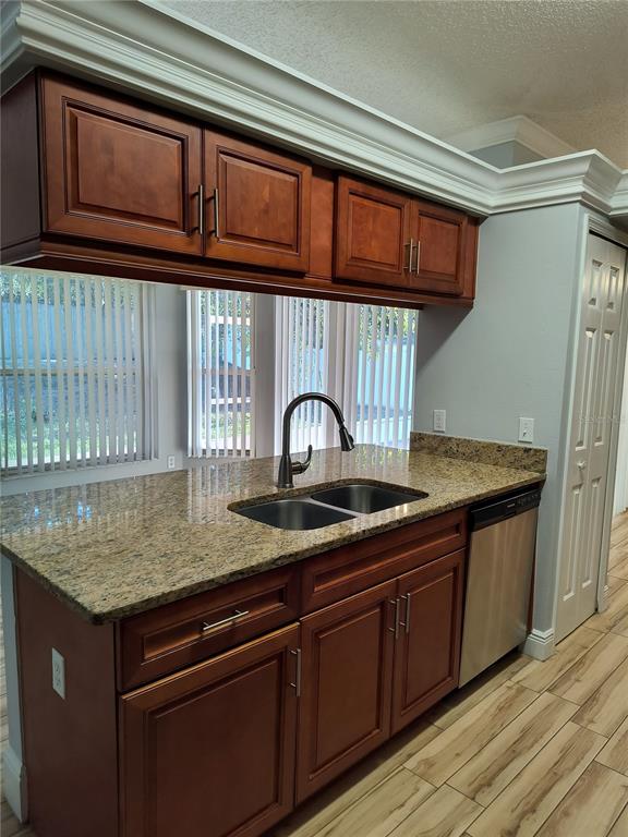 3201 Settlers Trail St. Cloud, FL 34772 - Photo 25 of 38 a kitchen with granite countertop wood cabinets and a sink