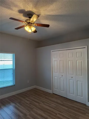 a view of a room with a window and wooden floor