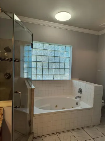 a view of a hallway with wooden floor and closet
