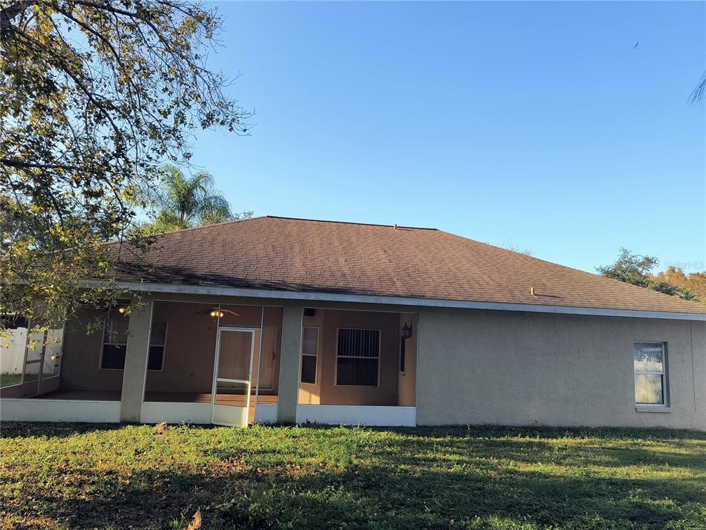 3201 Settlers Trail St. Cloud, FL 34772 - Photo 37 of 38 a front view of a house with a yard and garage
