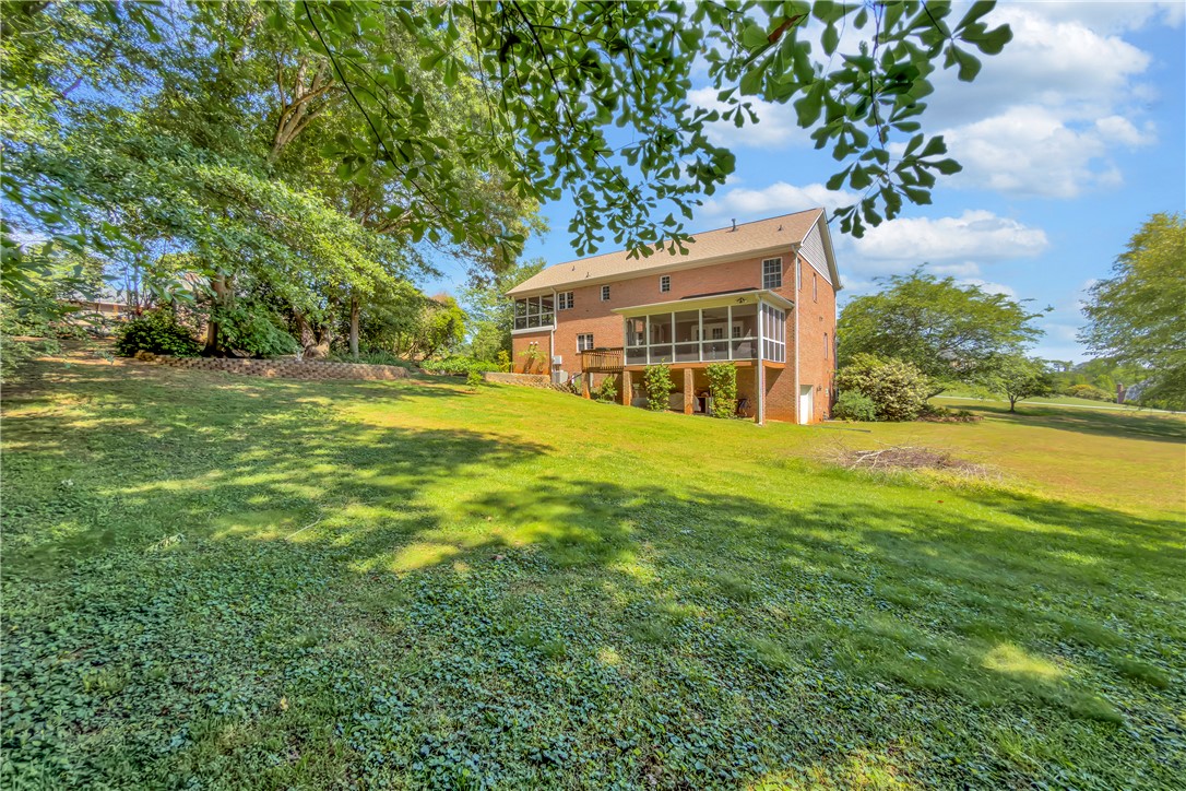 406 Hopewell Ridge Anderson, SC 29621 - Photo 41 of 46 This expansive backyard offers ample green space and a delightful screened porch for outdoor enjoyment.