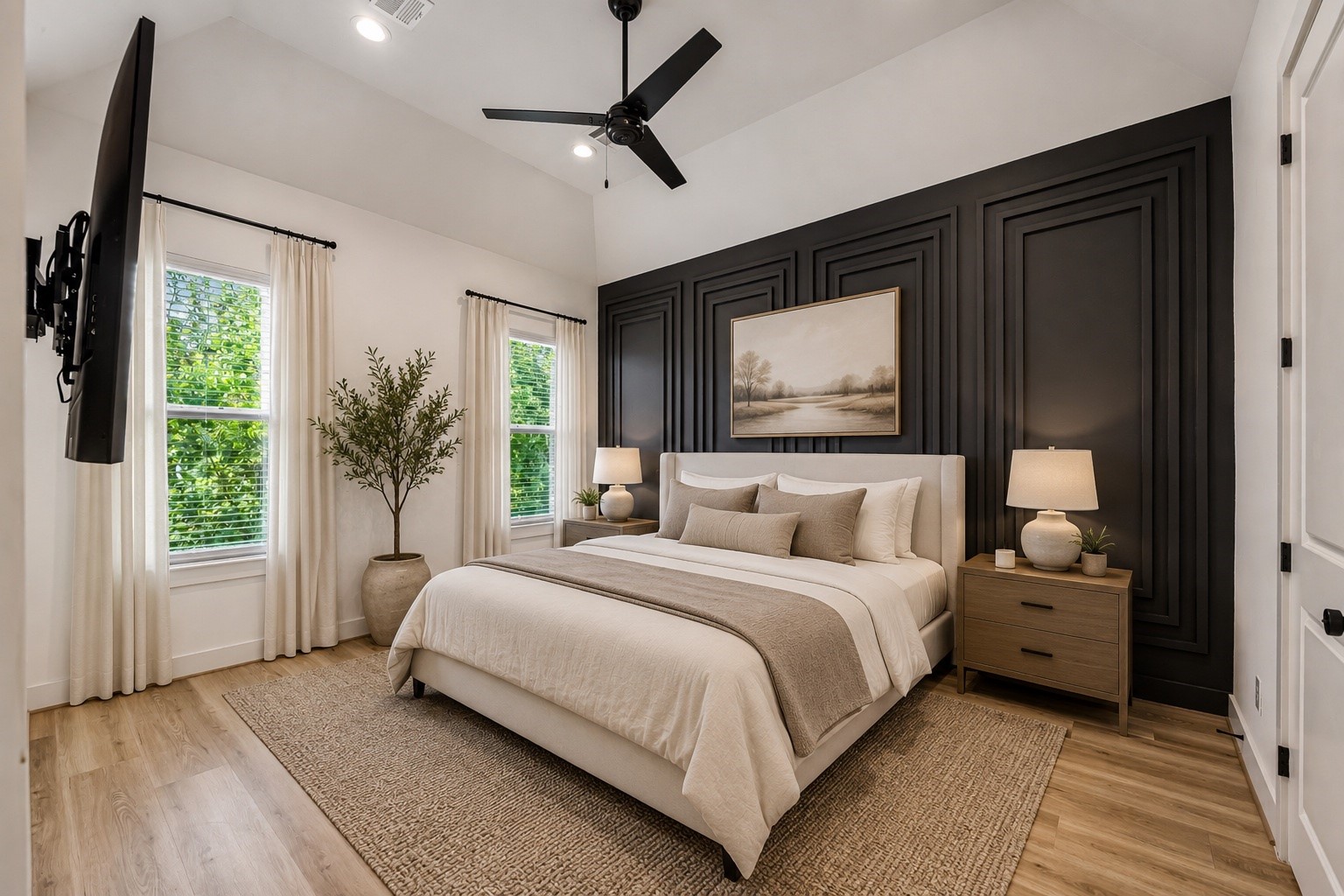 *Virtually staged* sizable primary bedroom with custom accent wall and vaulted ceilings.