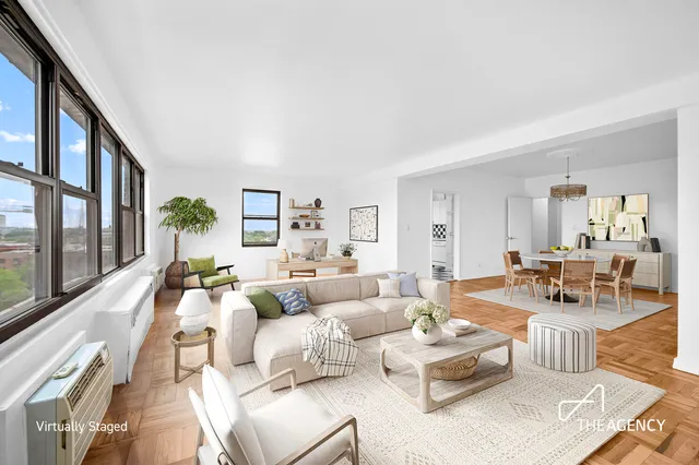 a living room with furniture large window and a table