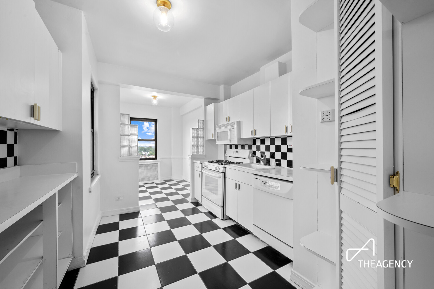 303 Beverley Road, Unit 11A Brooklyn, NY 11218 - Photo 4 of 11 a kitchen with a checkered floor and white cabinets