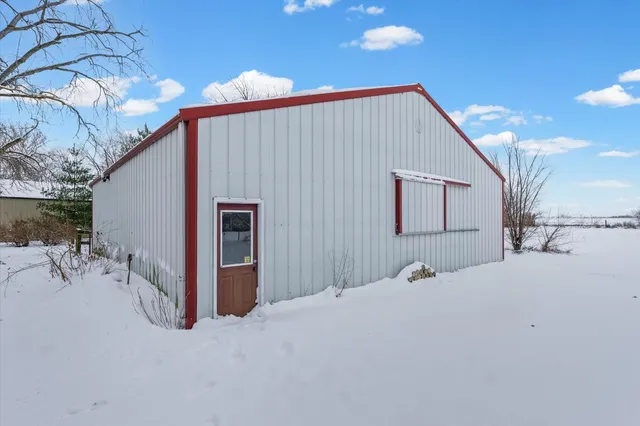 a view of a patio with table and chairs with wooden fence and plants