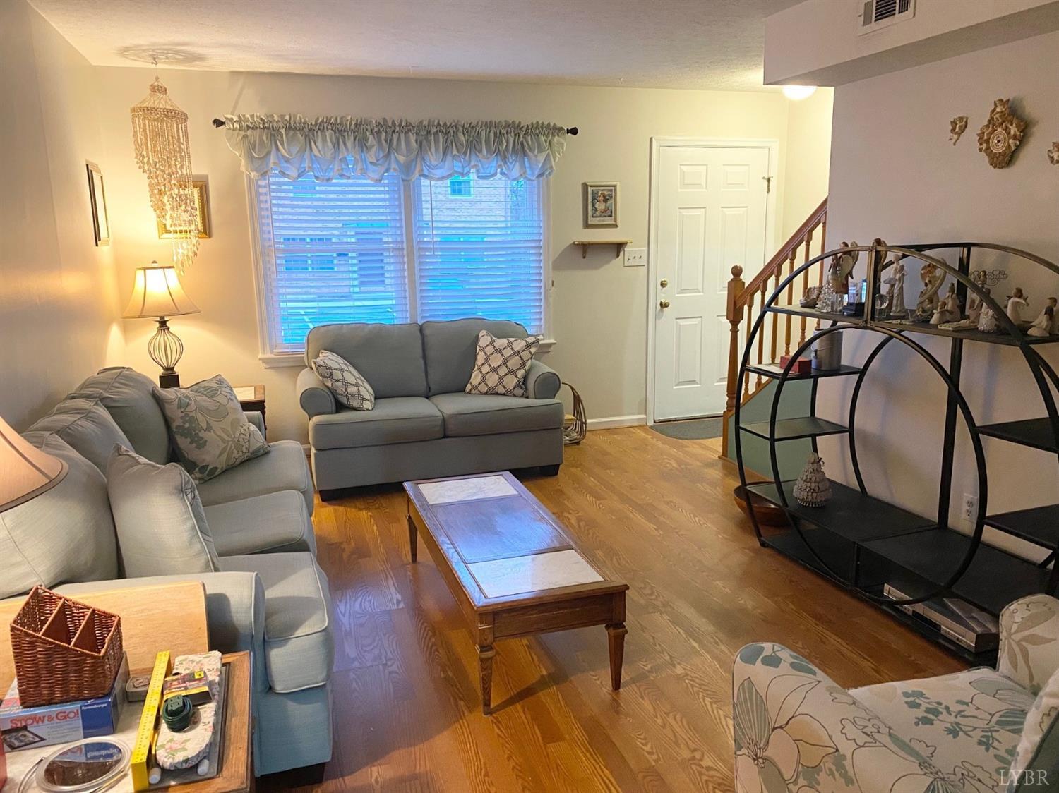 3501 Fort Avenue, Unit 29 Lynchburg, VA 24501 - Photo 3 of 16 a living room with furniture a window and a lamp