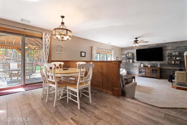 a view of a dining room with furniture wooden floor and chandelier
