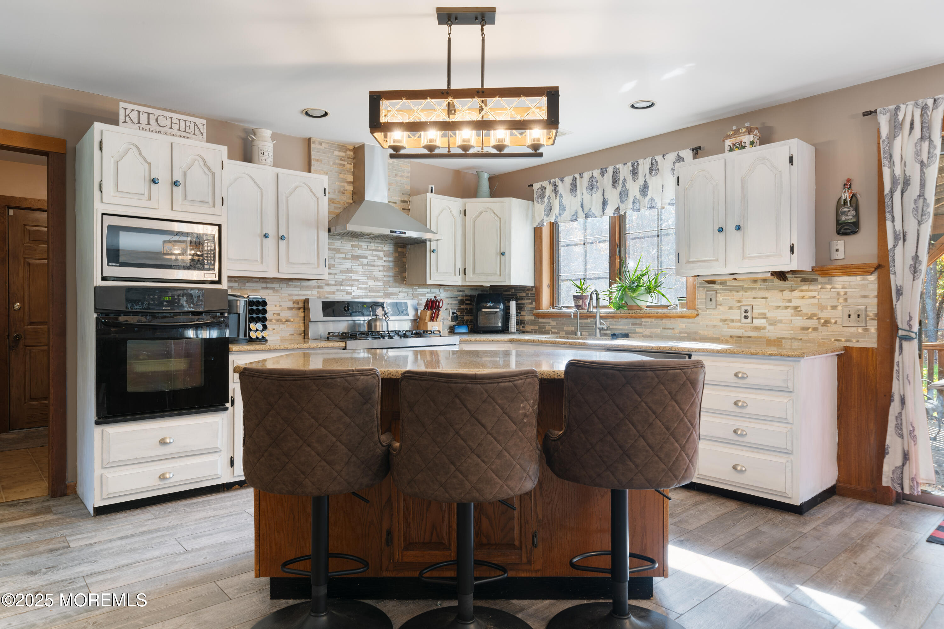 1226 Andover Road Forked River, NJ 08731 - Photo 17 of 44 a kitchen with a table chairs refrigerator and cabinets