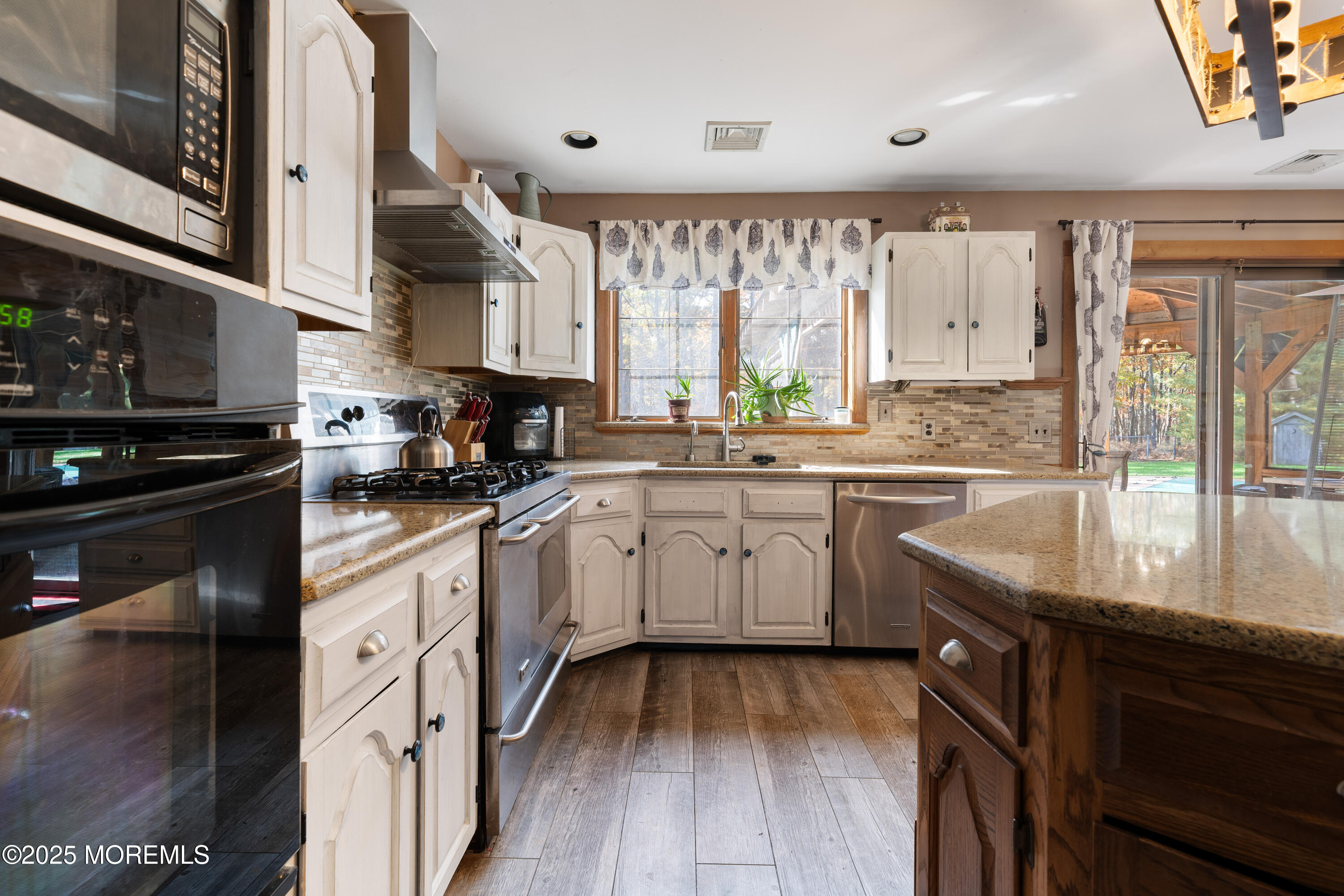 1226 Andover Road Forked River, NJ 08731 - Photo 18 of 44 a kitchen with a sink window and cabinets