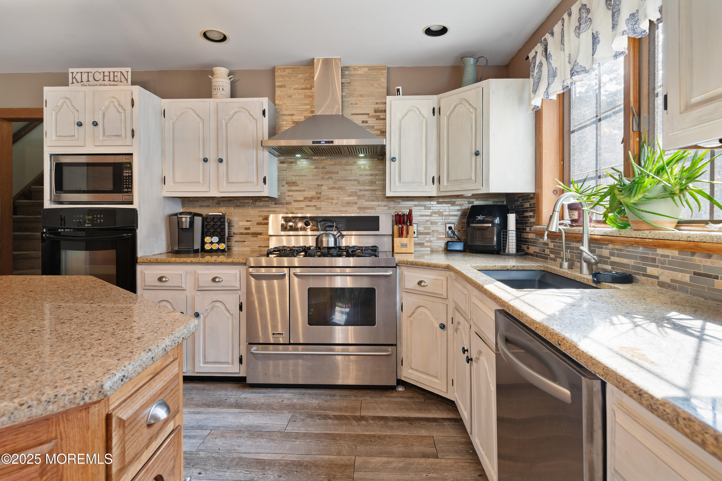 1226 Andover Road Forked River, NJ 08731 - Photo 19 of 44 a kitchen with stainless steel appliances granite countertop a stove a sink and a microwave