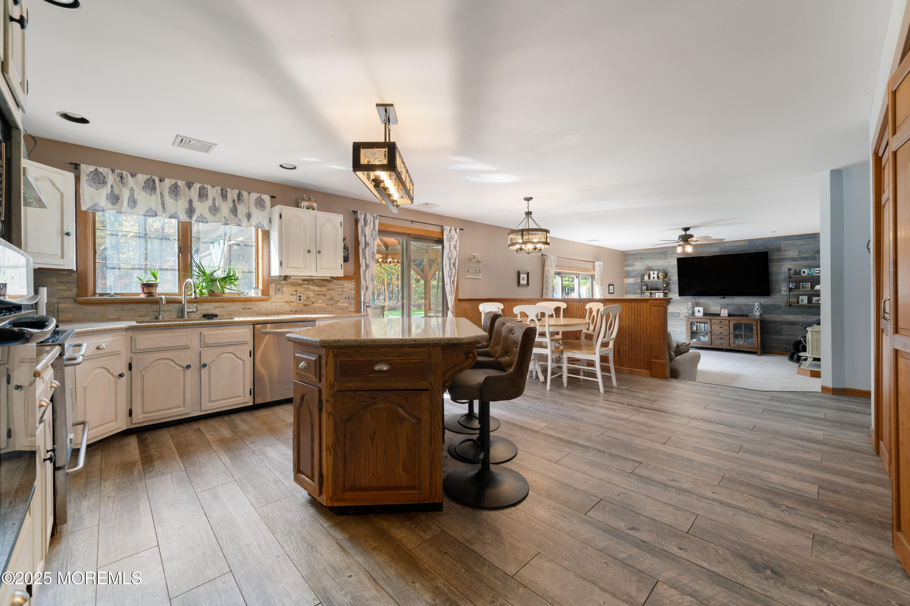 1226 Andover Road Forked River, NJ 08731 - Photo 20 of 44 a kitchen with stainless steel appliances wooden floors and wooden cabinets