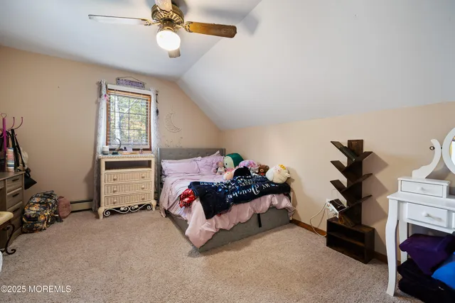 a bedroom with bed and a chandelier