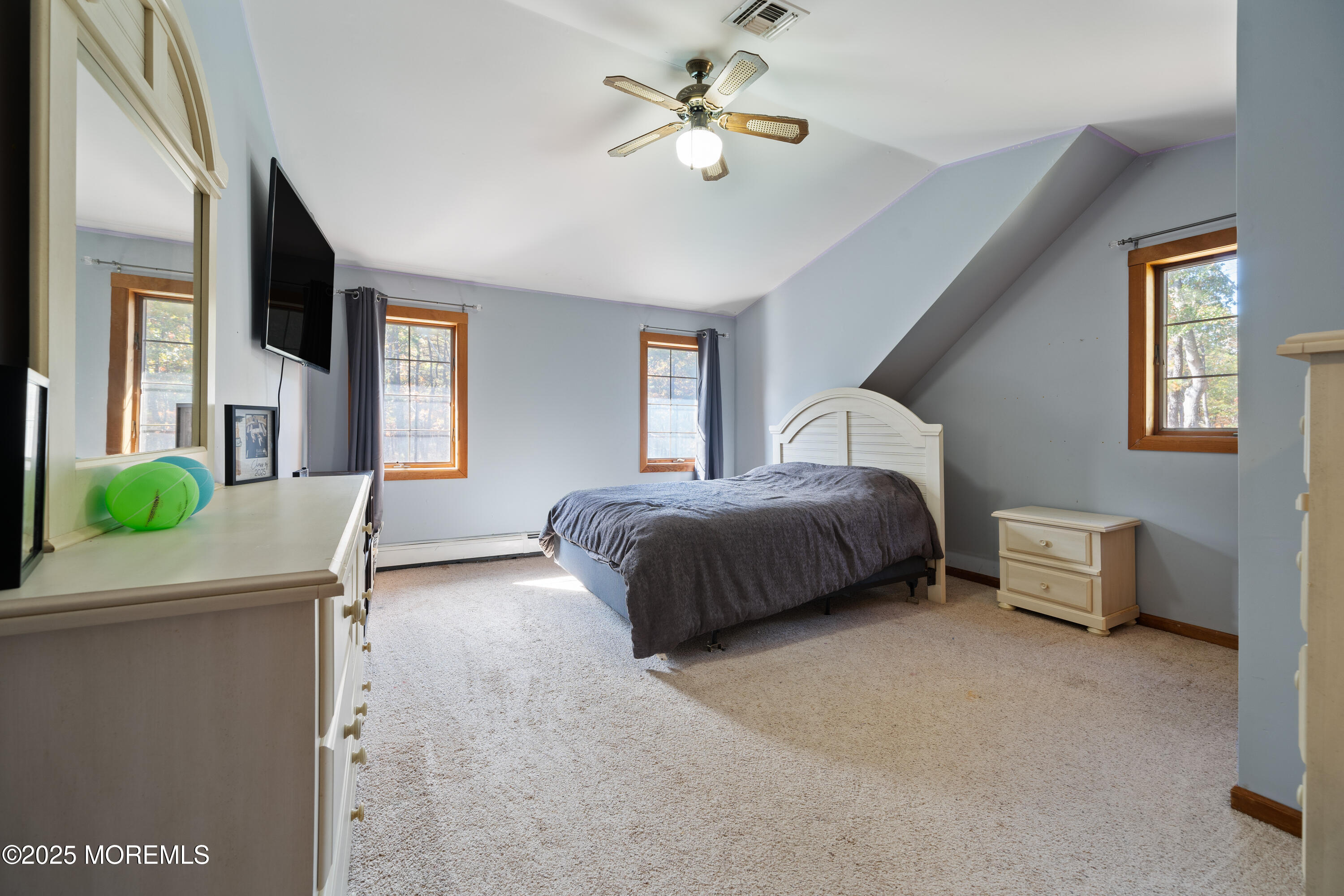 1226 Andover Road Forked River, NJ 08731 - Photo 24 of 44 a spacious bedroom with a bed and a chandelier