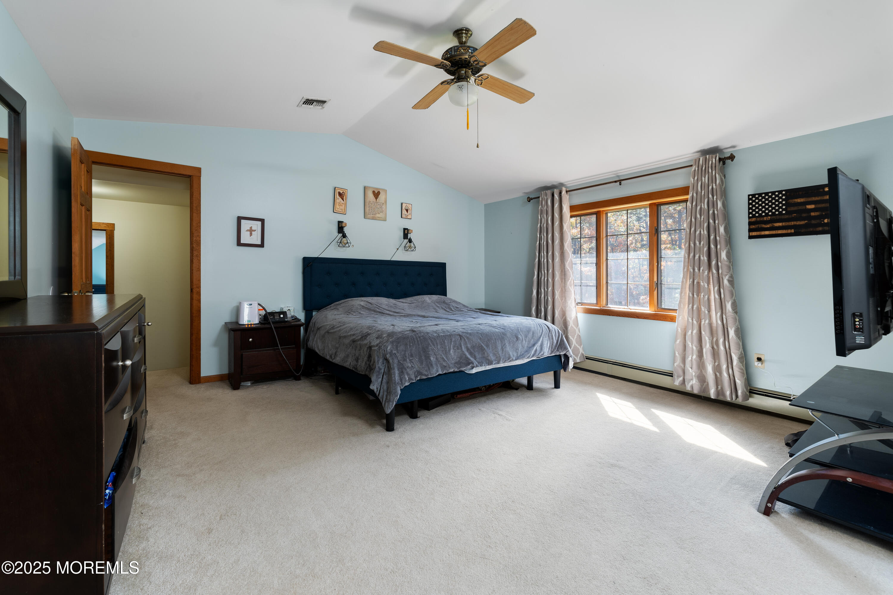 1226 Andover Road Forked River, NJ 08731 - Photo 26 of 44 a bedroom with a bed and a chandelier