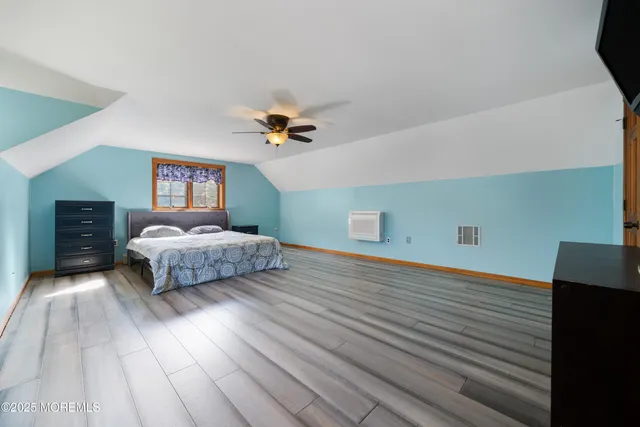 a bedroom with a bed and a night stand