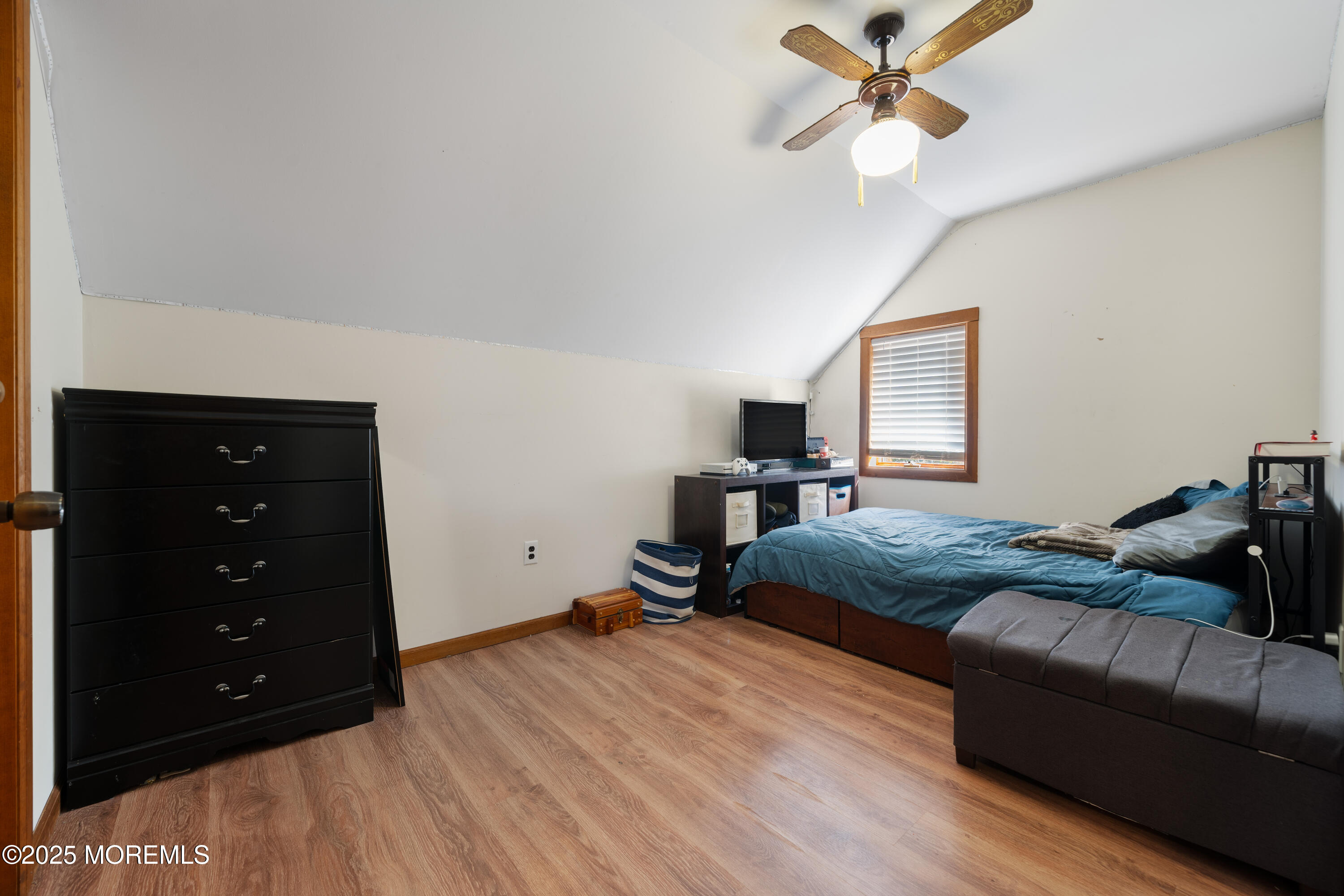 1226 Andover Road Forked River, NJ 08731 - Photo 29 of 44 a bedroom with a bed and wooden floor
