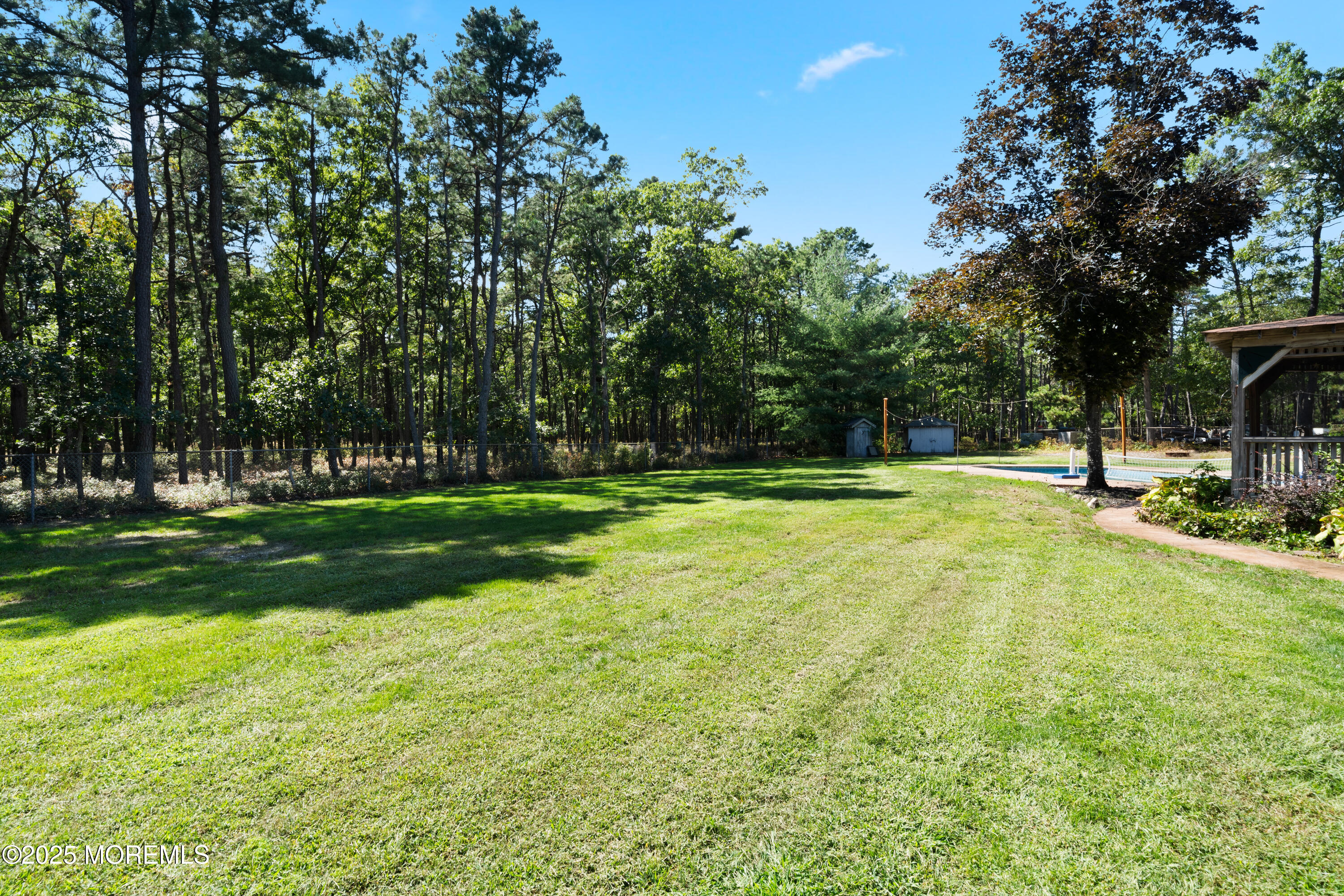 1226 Andover Road Forked River, NJ 08731 - Photo 31 of 44 a swimming pool with trees in the background