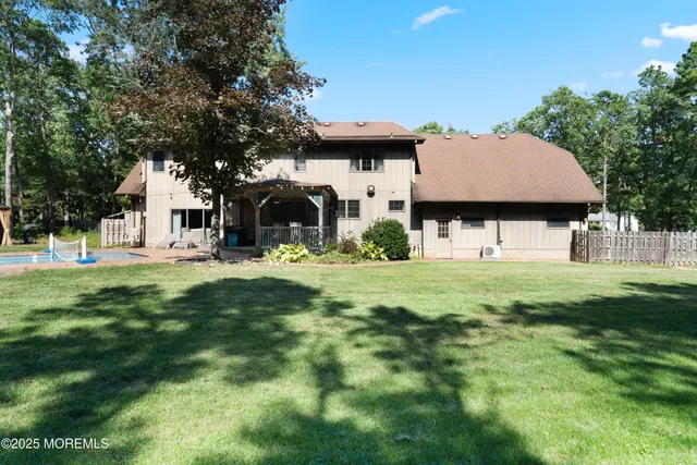 a view of a house with a backyard