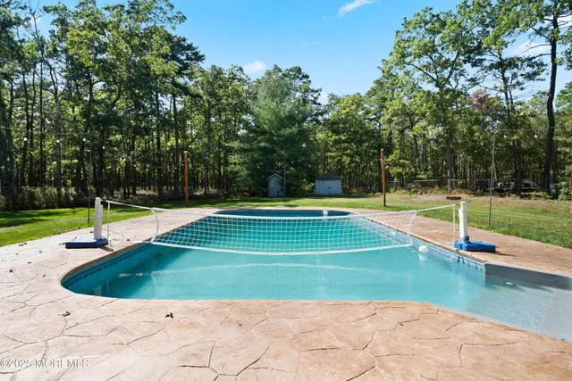 a view of a swimming pool with a yard