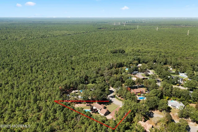 a view of a green field with lots of bushes