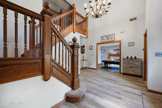 a view of entryway bedroom and hall with wooden floor