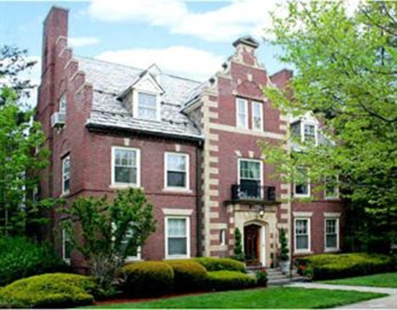 front view of a brick house with a yard