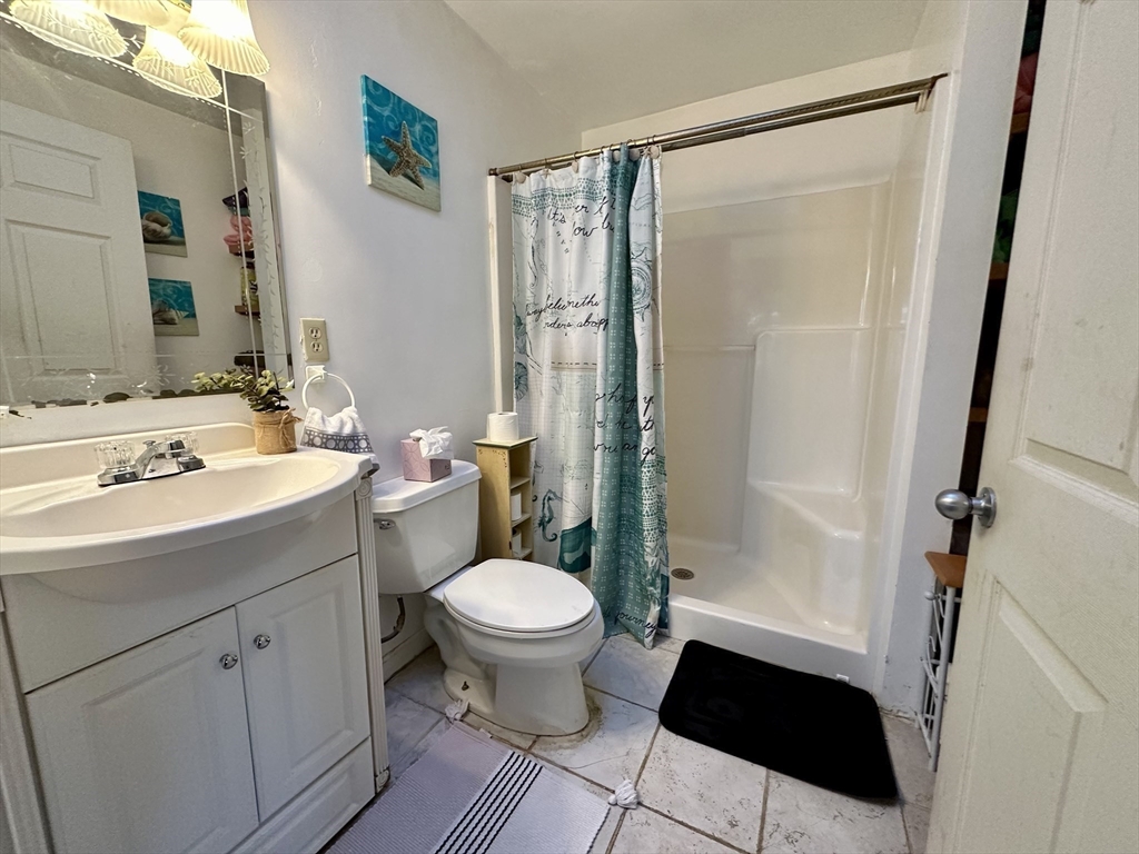 53 Dellwood Road Worcester, MA 01602 - Photo 8 of 24 a bathroom with a sink toilet a mirror and shower