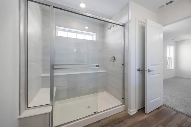 a bathroom with a glass shower door