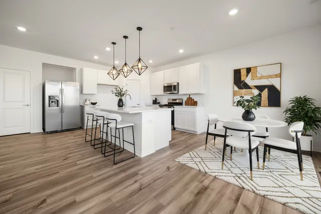 a view of a dining room with furniture and chandelier