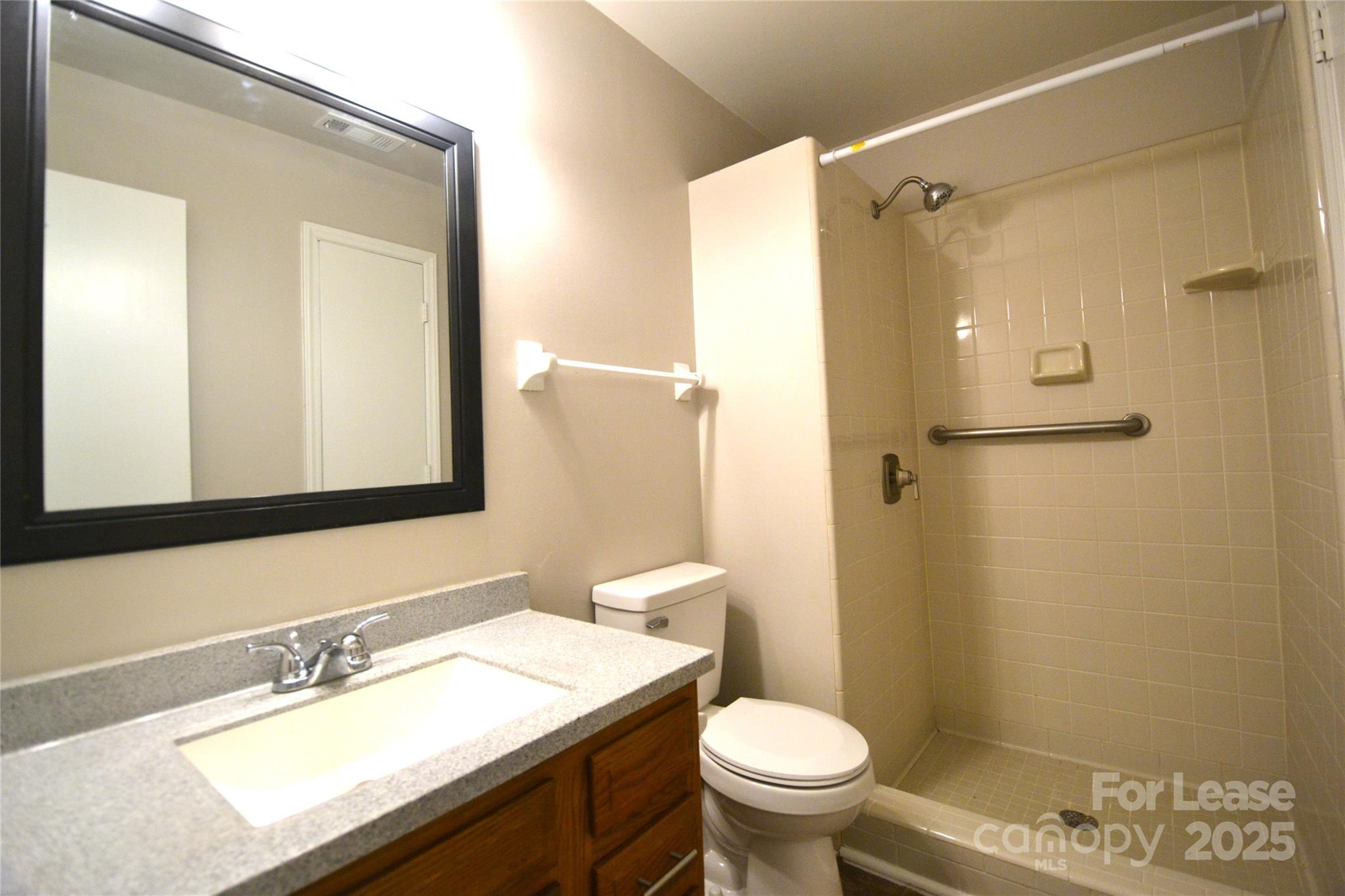 8317 Summer Glen Circle Charlotte, NC 28227 - Photo 18 of 30 a bathroom with a granite countertop sink toilet and shower